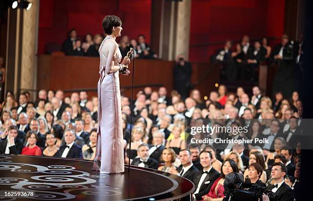 Actress Anne Hathaway accepts the Best Supporting Actress award for "Les Miserables," seen from backstage during the Oscars held at the Dolby Theatre...