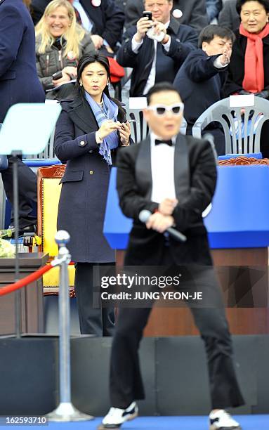 South Korean rapper Park Jae-Sang , also known as "Psy", dances as Thai Prime Minister Yingluck Shinawatra looks on before the presidential...