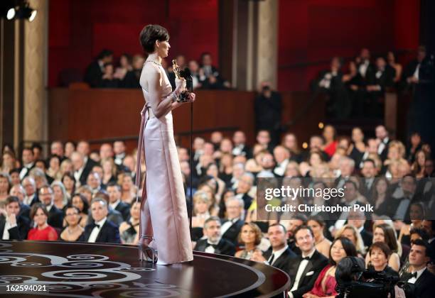 Actress Anne Hathaway accepts the Best Supporting Actress award for "Les Miserables," seen from backstage during the Oscars held at the Dolby Theatre...