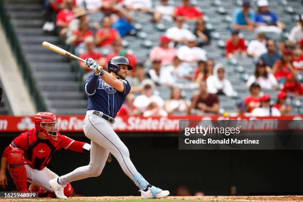 Josh Lowe of the Tampa Bay Rays singles against the Los Angeles Angels in the fifth inning during game one of a doubleheader at Angel Stadium of...