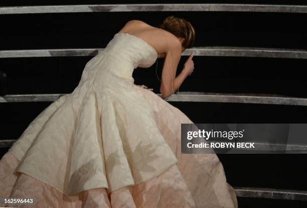 Best Actress winner Jennifer Lawrence falls onstage at the 85th Annual Academy Awards on February 24, 2013 in Hollywood, California. AFP PHOTO/Robyn...