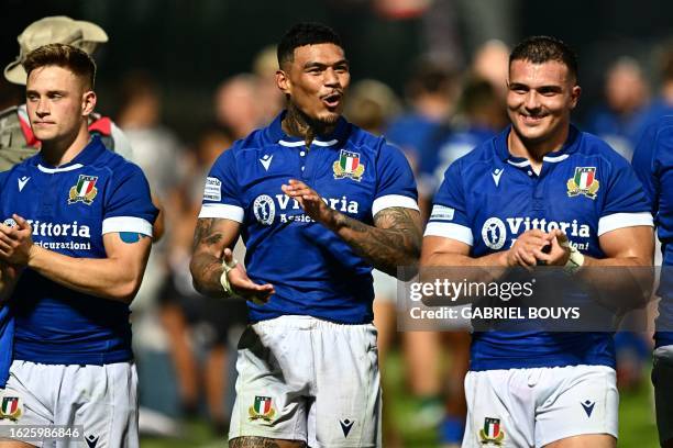 Italy's winger Montanna Ioane celebrates with teammates Italy's scrum-half Stephen Varney and Italy's prop Danilo Fischetti during the Rugby union...