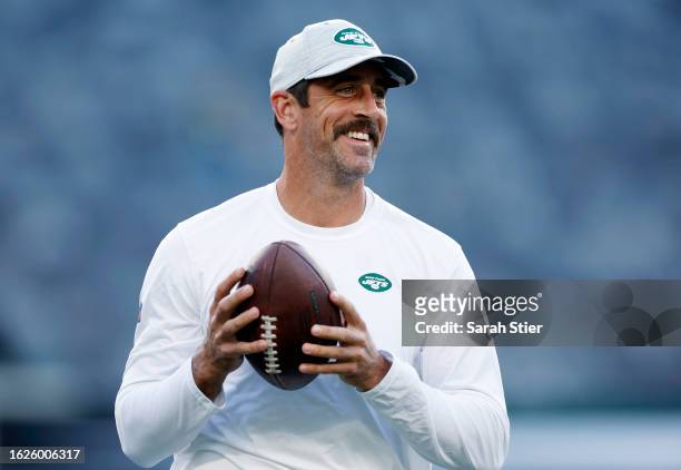 Aaron Rodgers of the New York Jets throws the ball during warmups before the first half of a preseason game against the Tampa Bay Buccaneers at...