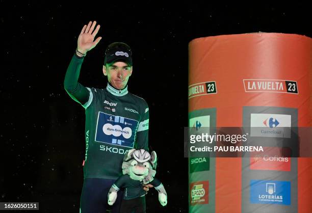 Team Dsm's French rider Romain Bardet wearing the overall points leader's green jersey celebrates on the podium after the first stage of the 2023 La...