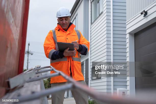 a site manager checking his reports - quality control inspectors stock pictures, royalty-free photos & images