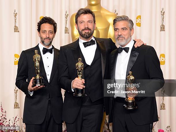 Producer Grant Heslov, actor-producer-director Ben Affleck, and producer George Clooney, winners of the Best Picture award for "Argo," pose in the...