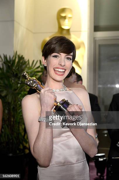 Actress Anne Hathaway holds her trophy for Best Supporting Actress for her performance in 'Les Misérables ' as she attends the Oscars Governors Ball...