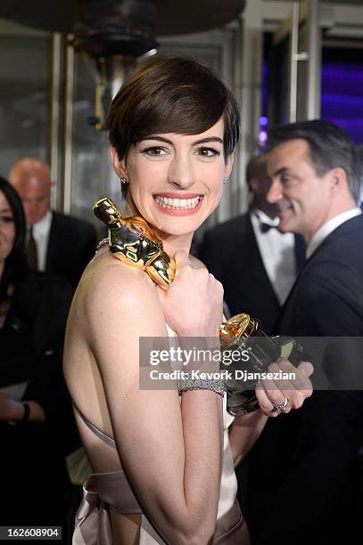Actress Anne Hathaway holds her trophy for Best Supporting Actress for her performance in 'Les Misérables ' as she attends the Oscars Governors Ball...