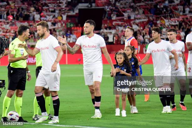 Sevilla's Croatian midfielder Ivan Rakitic, Sevilla's Argentinian forward Lucas Ocampos and Sevilla's Spanish midfielder Oliver Torres, wearing a...