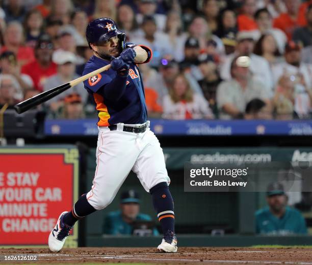 Jose Altuve of the Houston Astros singles in the first inning against the Seattle Mariners at Minute Maid Park on August 19, 2023 in Houston, Texas....