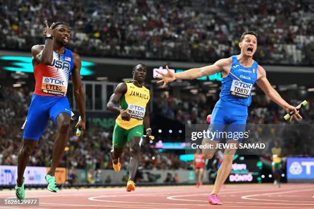 S Noah Lyles and Italy's Filippo Tortu react after the men's 4x100m relay final during the World Athletics Championships at the National Athletics...