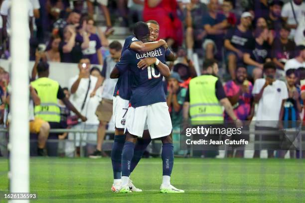 Kylian Mbappe of PSG celebrates his goal with Ousmane Dembele during the Ligue 1 Uber Eats match between Toulouse FC and Paris Saint-Germain at...