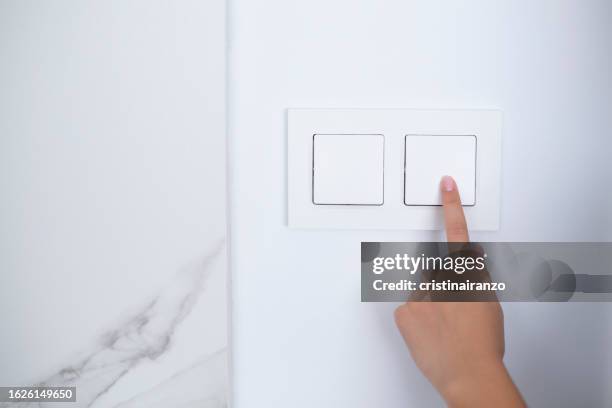 finger of girl turning off switch at home - cable bill stock pictures, royalty-free photos & images