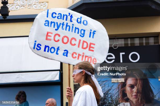 Dozen climate activists from extinction rebellion bonn gather at old town Hall in Bonn on August 26, 2023 and protest against Ecocide as World...