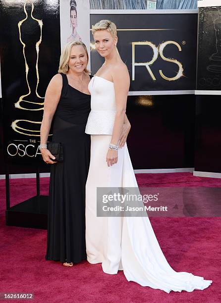 Charlize Theron and Gerda Jacoba Aletta Maritz arrive at the Oscars at Hollywood & Highland Center on February 24, 2013 in Hollywood, California.