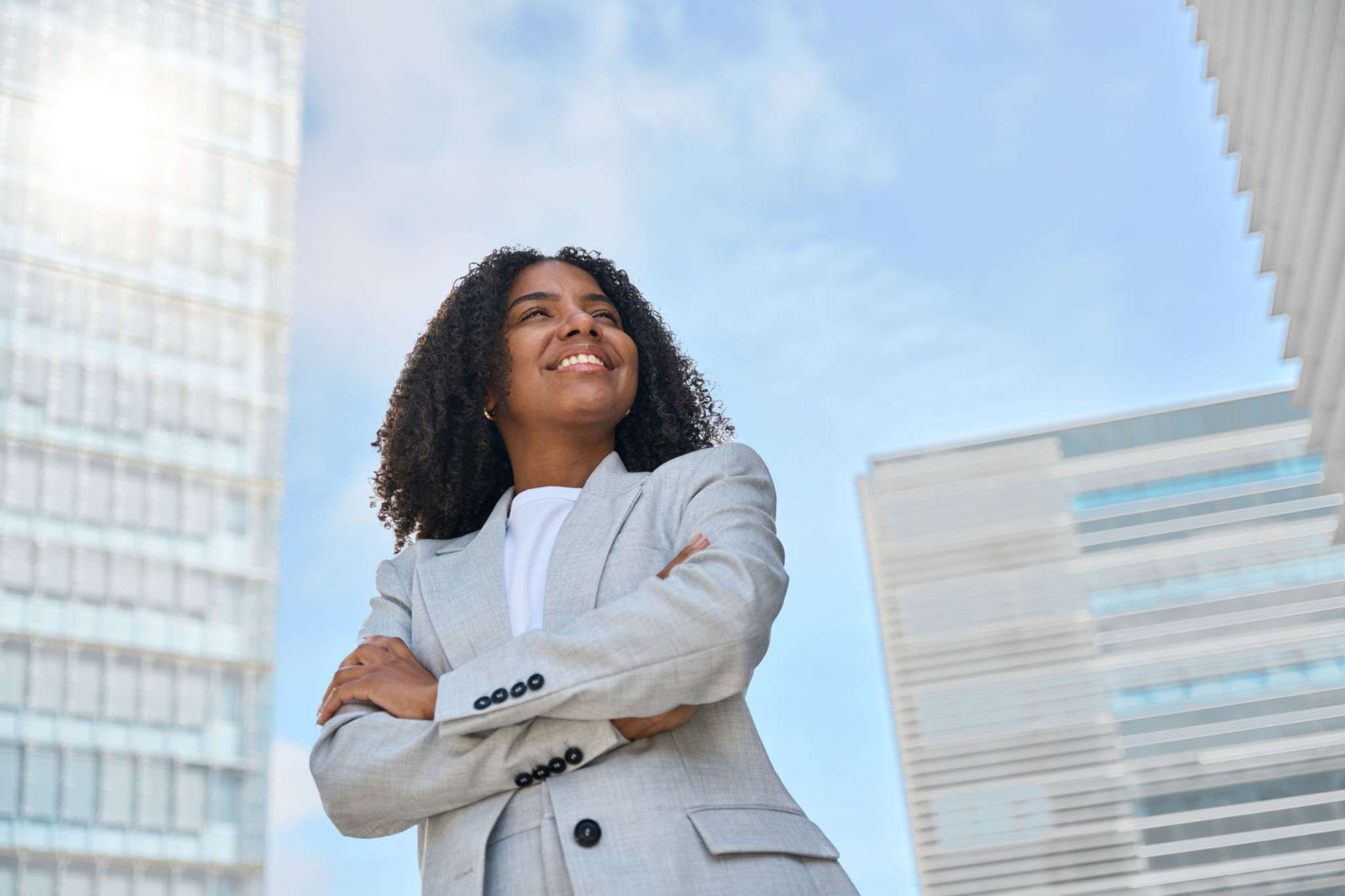 Happy young African American business woman standing in city feeling proud. Happy young African American business woman standing in city feeling proud.