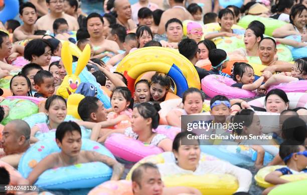 People cool off at a water park of Fuling Red Wine Town during the heat wave on August 19, 2023 in Chongqing, China.