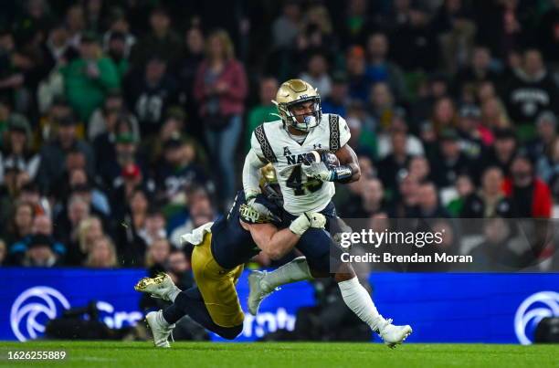 Dublin , Ireland - 26 August 2023; Navy Midshipmen fullback Daba Fofana is tackled by Notre Dame linebacker JD Bertrand during the Aer Lingus College...