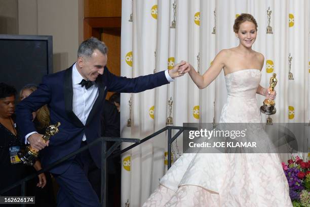 Best Actor Daniel Day-Lewis arrives in the peress room with Best Actress Jennifer Lawrence, Best Supporting Actress Anne Hathaway, and Best...