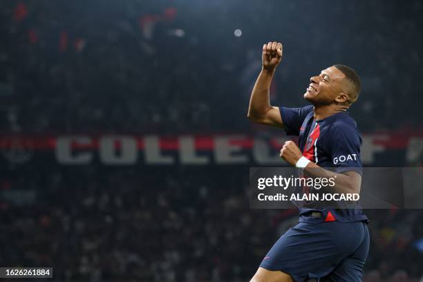 Paris Saint-Germain's French forward Kylian Mbappe punches the air as he celebrates scoring Paris Saint-Germain's third goal during the French L1...