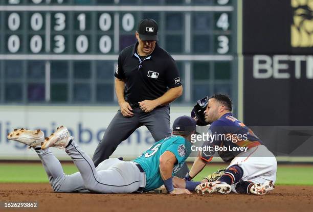 Jose Altuve of the Houston Astros is tagged out by Dylan Moore of the Seattle Mariners attempting to stretch a single in the fifth inning at Minute...