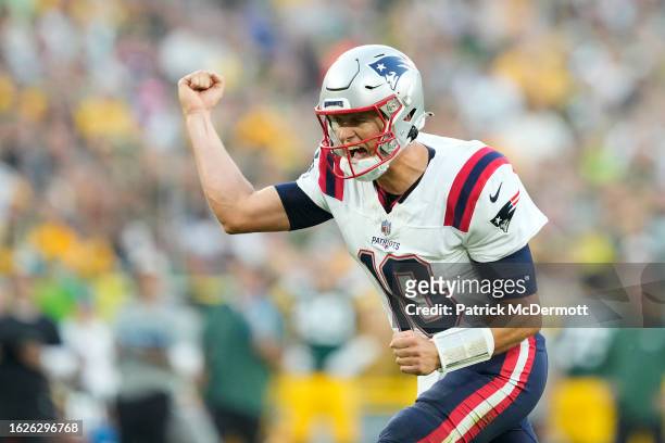 Mac Jones of the New England Patriots celebrates after a touchdown in the first quarter against the Green Bay Packers during a preseason game at...