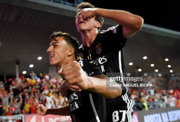 Benfica's Croatian forward Petar Musa celebrates scoring his team's third goal, with Benfica's Portuguese midfielder Joao Neves, during the...