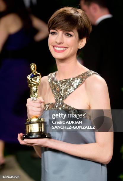 Anne Hathaway carrying her Oscar for best supporting actress arrives for the 2013 Vanity Fair Oscar Party on February 24, 2013 in Hollywood,...