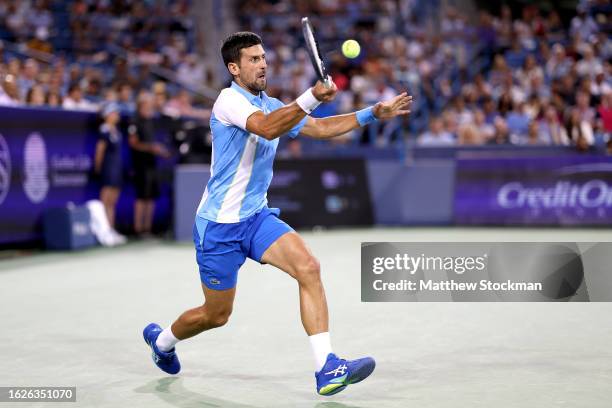 Ovak Djokovic of Serbia returns a shot to Alexander Zverev of Germany during the semifinals of the Western & Southern Open at Lindner Family Tennis...