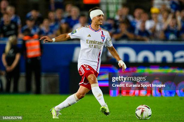 Maxence Caqueret of Lyon passes the ball during the Ligue 1 Uber Eats match between RC Strasbourg and Olympique Lyon at Stade de la Meinau on August...