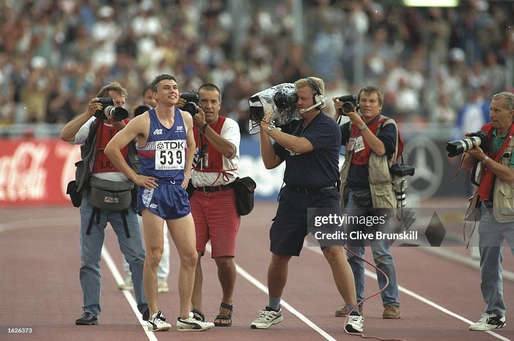Jonathan Edwards of Great Britain is surrounded by the press after winning the Triple Jump event