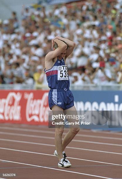 Jonathan Edwards walks on the track holding his head in disbelief after setting a new World Record in the Triple Jump event with a jump of 18:29...