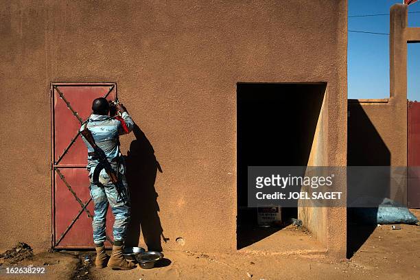 Malian gendarme locks a door of an improvised jail on February 24, 2013 in the office of the gendarmerie in Gao. After recapturing the north's cities...