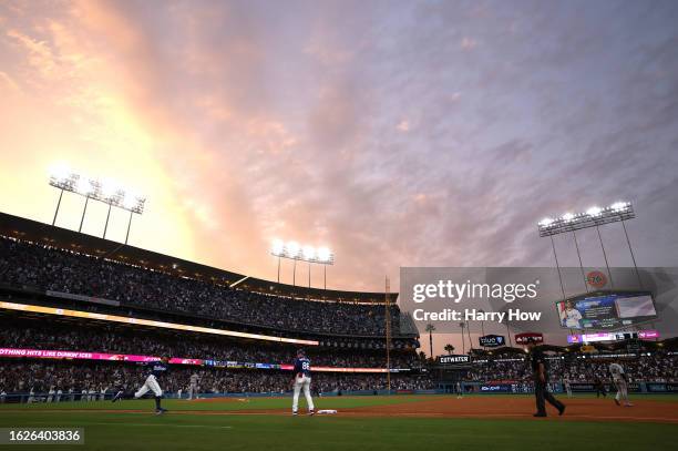 Mookie Betts of the Los Angeles Dodgers runs to first after his solo home run, his second home run of the night, to take a 3-1 lead over the Miami...