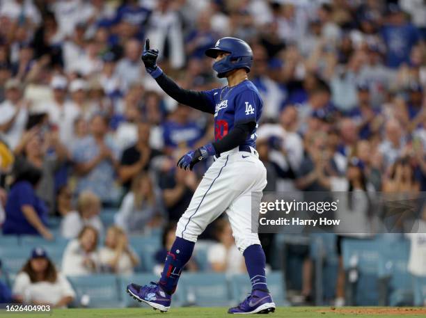 Mookie Betts of the Los Angeles Dodgers celebrates his solo home run, his second home run of the night, to take a 3-1 lead over the Miami Marlins,...