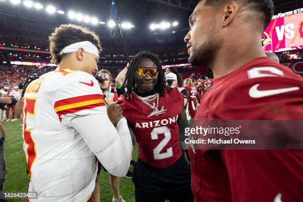 Patrick Mahomes of the Kansas City Chiefs meets with Marquise Brown of the Arizona Cardinals following an NFL preseason football game at State Farm...
