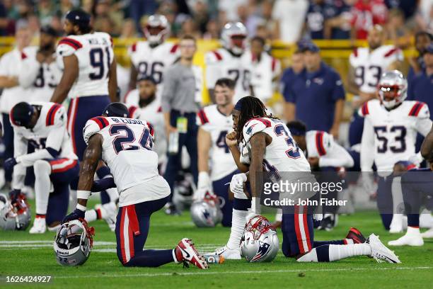 New England Patriots players take a knee after an injury to Isaiah Bolden of the New England Patriots during a preseason game at Lambeau Field on...