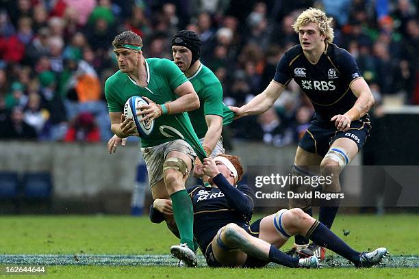 Jamie Heaslip of Ireland is hauled down by Robert Harley of Scotland during the RBS Six Nations match between Scotland and Ireland at Murrayfield...