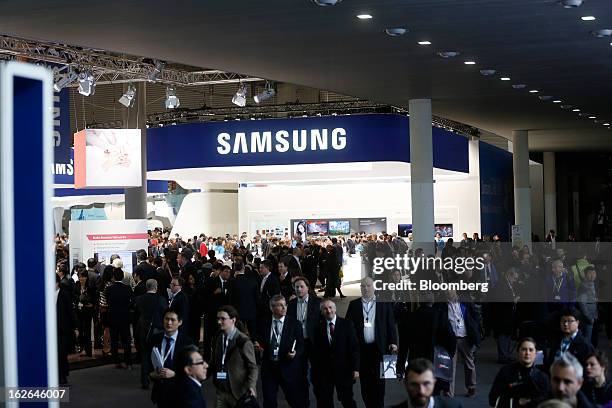 Visitors pass the Samsung Electronics Co. Pavilion at the Mobile World Congress in Barcelona, Spain, on Monday, Feb. 25, 2013. The Mobile World...