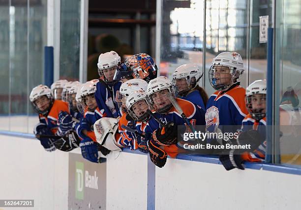 Youth players wait to get on the ice during an appearance by Hockey Hall of Famer Wayne Gretzky at the Abe Stark Arena on February 25, 2013 in New...