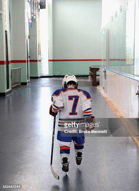 Youth player waits to get on the ice during an appearance by Hockey Hall of Famer Wayne Gretzky at the Abe Stark Arena on February 25, 2013 in New...
