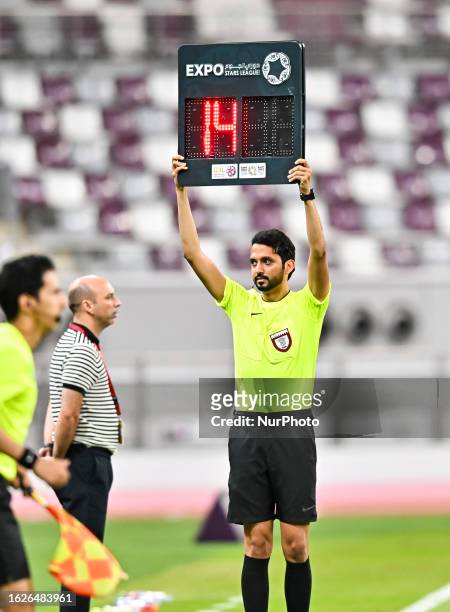 Referee Hussain Abdulla Alsayed holds the board up for extra time during the EXPO Stars League 23/24 match between Al Sadd SC and Al Ahli SC at...