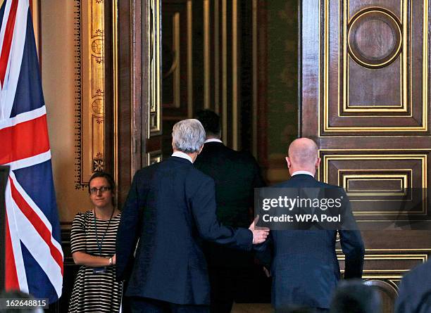 Secretary of State John Kerry and Britain's Foreign Secretary William Hague are seen as they leave the room following a joint news conference on...