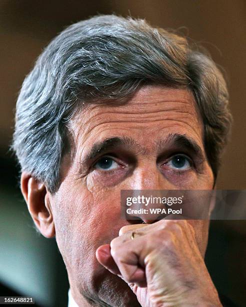 Secretary of State John Kerry listens to a reporter's question during a joint news conference with Britain's Foreign Secretary William Hague on...