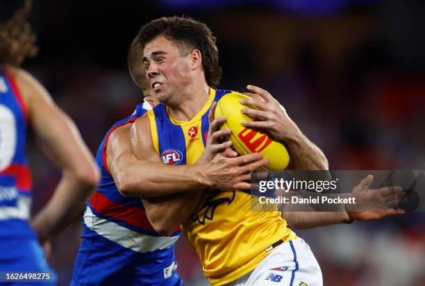 Campbell Chesser of the Eagles is tackled by Liam Jones of the Bulldogs during the round 23 AFL match between Western Bulldogs and West Coast Eagles...