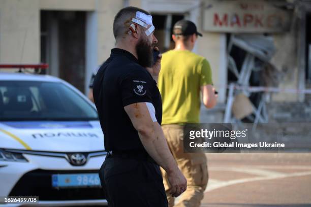 Police officer with a head and an arm wounds is at the site of a missile strike on the Drama Theater and the city's central square on August 19, 2023...