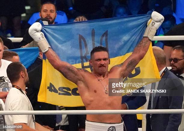Ukraine's reigning world heavyweight champion Oleksandr Usyk celebrates winning his fight against challenger Daniel Dubois of Great Britain at...