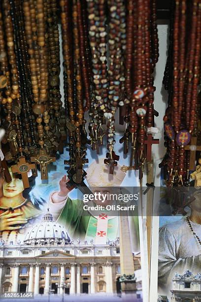 Rosary beads are displayed for sale next to an image of Pope Benedict XVI on February 25, 2013 in Rome, Italy. The Pontiff will hold his last weekly...