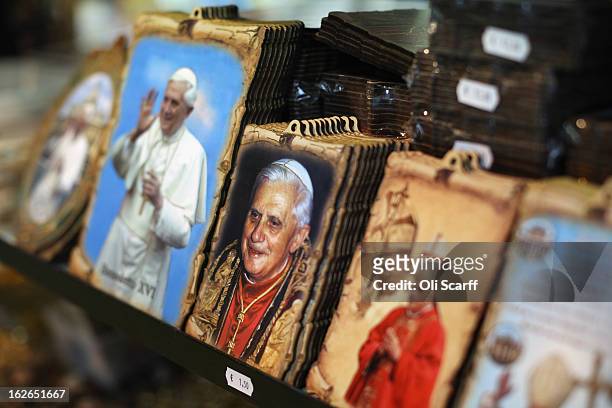 Souvenir photographs bearing the image of Pope Benedict XVI are displayed for sale on February 25, 2013 in Rome, Italy. The Pontiff will hold his...