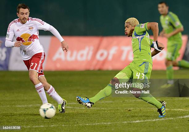 Travis Bowen of the Seattle Sounders kicks the ball past Andrew Ribeiro of the New York Red Bulls at Kino Sports Complex on February 20, 2013 in...